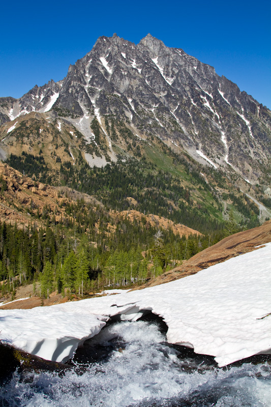 Stream Cut Snowbank And Mount Stuart